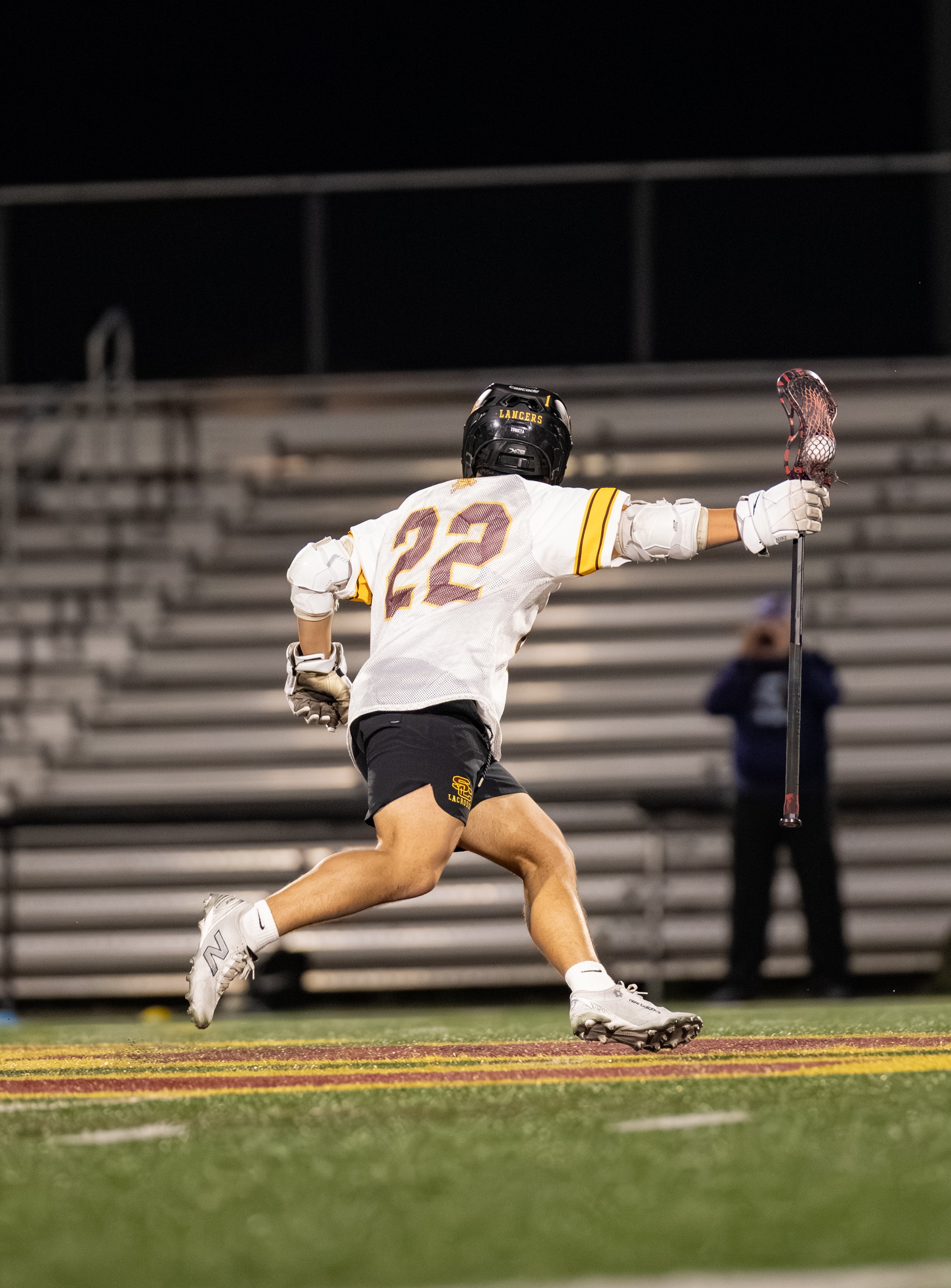 Lacrosse player running the field